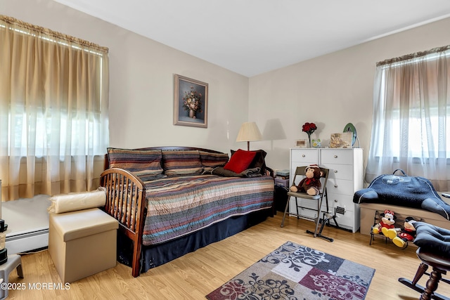 7 Beaverbrook Dr, Toms River, NJ 08757 - bedroom with a baseboard heating unit, wood finished floors, and a baseboard radiator