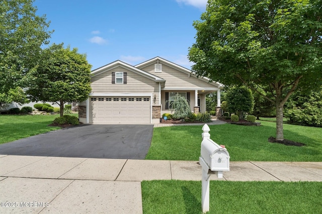 6 Day Star Rd, Manalapan, NJ 07726 - craftsman-style house featuring asphalt driveway, a front lawn, an attached garage, and covered porch