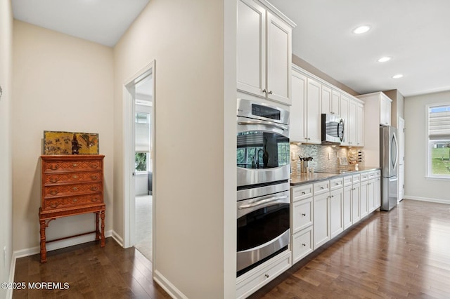 6 Day Star Rd, Manalapan, NJ 07726 - kitchen featuring appliances with stainless steel finishes, dark wood finished floors, recessed lighting, backsplash, and white cabinets