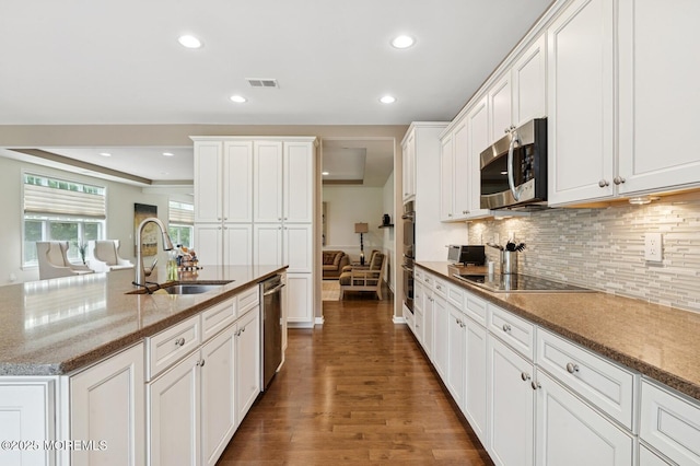 6 Day Star Rd, Manalapan, NJ 07726 - kitchen featuring stainless steel appliances, dark wood finished floors, recessed lighting, tasteful backsplash, and white cabinetry