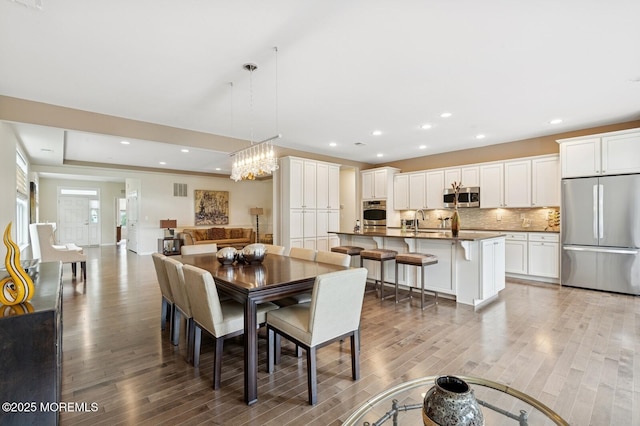 6 Day Star Rd, Manalapan, NJ 07726 - dining area with light wood finished floors, recessed lighting, and a chandelier