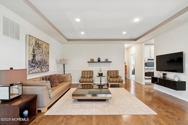 6 Day Star Rd, Manalapan, NJ 07726 - living room with a raised ceiling, wood finished floors, and recessed lighting