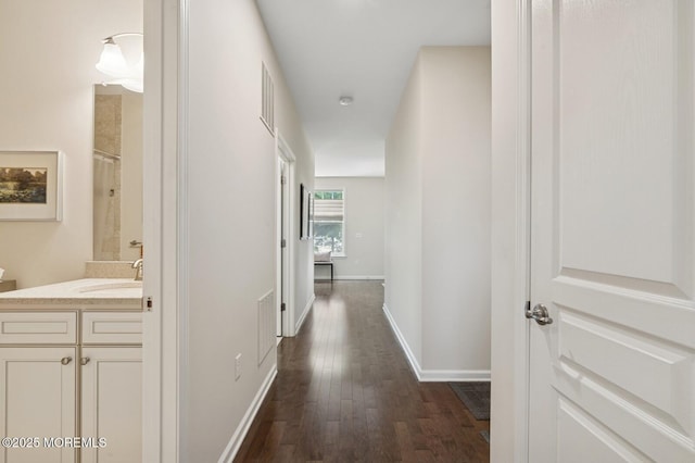 6 Day Star Rd, Manalapan, NJ 07726 - hallway featuring dark wood-style flooring and a sink