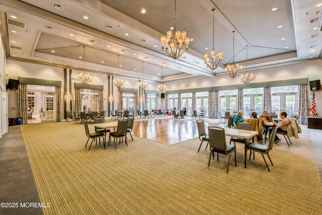 6 Day Star Rd, Manalapan, NJ 07726 - carpeted dining space with a tray ceiling, a towering ceiling, a chandelier, and recessed lighting