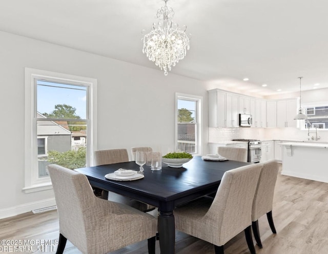 204 Morningside Ave, Union Beach, NJ 07735 - dining space featuring light wood-type flooring, a chandelier, and recessed lighting