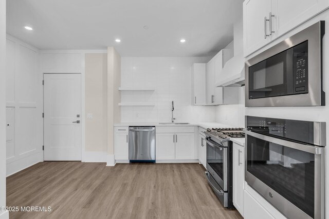 218 3rd Ave Unit 204, Asbury Park, NJ 07712 - kitchen featuring appliances with stainless steel finishes, light wood-style floors, white cabinetry, open shelves, and recessed lighting
