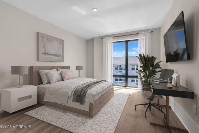 218 3rd Ave Unit 204, Asbury Park, NJ 07712 - bedroom with wood finished floors, an office area, and access to outside