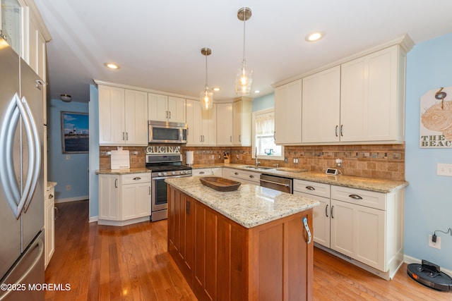 45 Fielder Ave, Seaside Heights, NJ 08751 - kitchen with stainless steel appliances, hardwood / wood-style flooring, white cabinets, tasteful backsplash, and recessed lighting