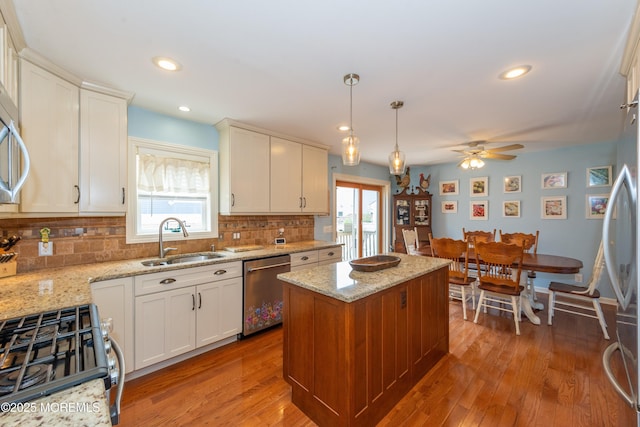 45 Fielder Ave, Seaside Heights, NJ 08751 - kitchen with stainless steel appliances, a ceiling fan, tasteful backsplash, a center island, and white cabinets