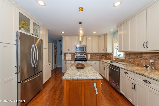 45 Fielder Ave, Seaside Heights, NJ 08751 - kitchen with appliances with stainless steel finishes, a center island, dark wood-style flooring, tasteful backsplash, and glass insert cabinets