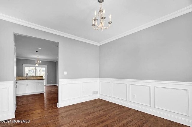 451 Woodbury Dr, Jackson, NJ 08527 - unfurnished dining area featuring a chandelier, dark wood finished floors, a wainscoted wall, and crown molding