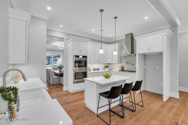 451 Woodbury Dr, Jackson, NJ 08527 - kitchen featuring appliances with stainless steel finishes, wall chimney range hood, decorative backsplash, light countertops, and white cabinetry
