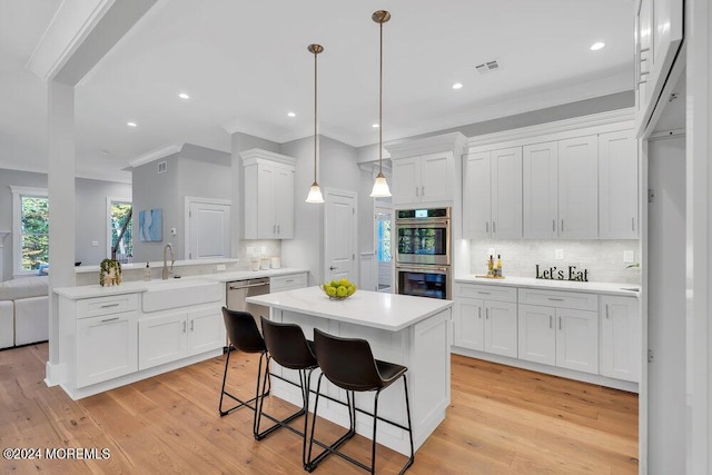 451 Woodbury Dr, Jackson, NJ 08527 - kitchen with appliances with stainless steel finishes, a peninsula, light countertops, white cabinets, and crown molding