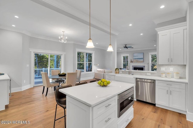 451 Woodbury Dr, Jackson, NJ 08527 - kitchen with stainless steel appliances, recessed lighting, light countertops, crown molding, and white cabinetry