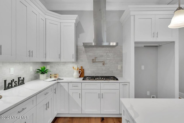 451 Woodbury Dr, Jackson, NJ 08527 - kitchen featuring wall chimney range hood, white cabinetry, tasteful backsplash, and light stone counters