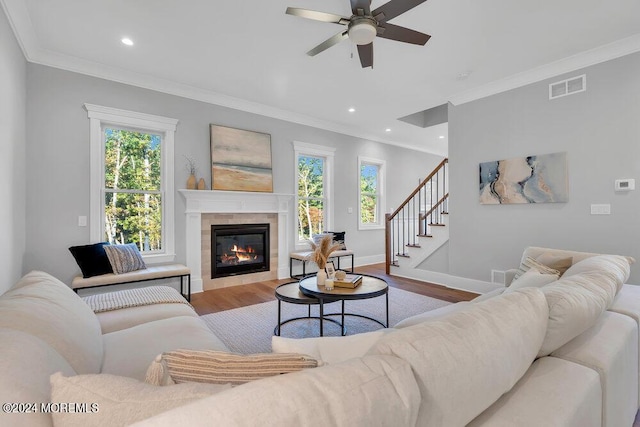 451 Woodbury Dr, Jackson, NJ 08527 - living area with wood finished floors, plenty of natural light, a ceiling fan, crown molding, and a tiled fireplace