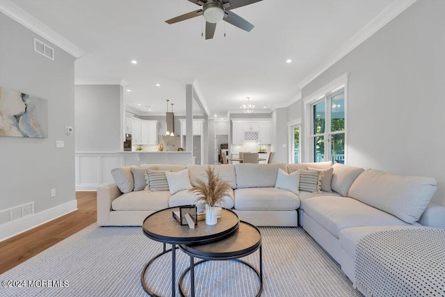451 Woodbury Dr, Jackson, NJ 08527 - living area with ornamental molding, light wood finished floors, a ceiling fan, a chandelier, and recessed lighting
