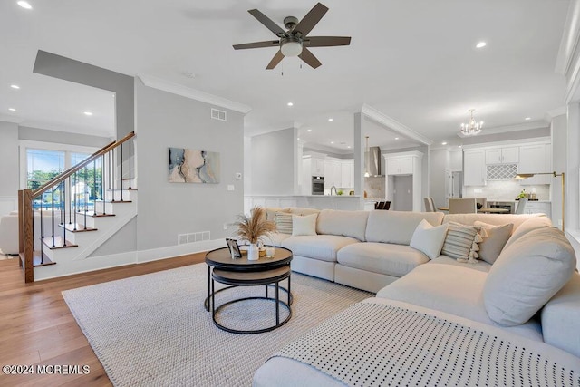 451 Woodbury Dr, Jackson, NJ 08527 - living room featuring crown molding, a ceiling fan, light wood-style flooring, recessed lighting, and a chandelier