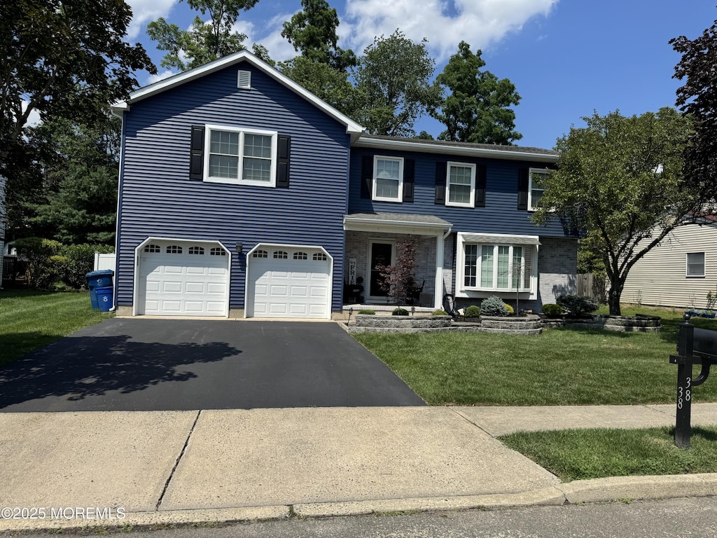 38 Cherry Tree Cir, Howell, NJ 07731 - traditional-style home with driveway, a garage, and a front lawn