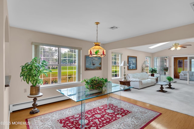 59 Mansfield Dr, Brick, NJ 08724 - living area with a baseboard heating unit, ceiling fan, a skylight, wood finished floors, and vaulted ceiling