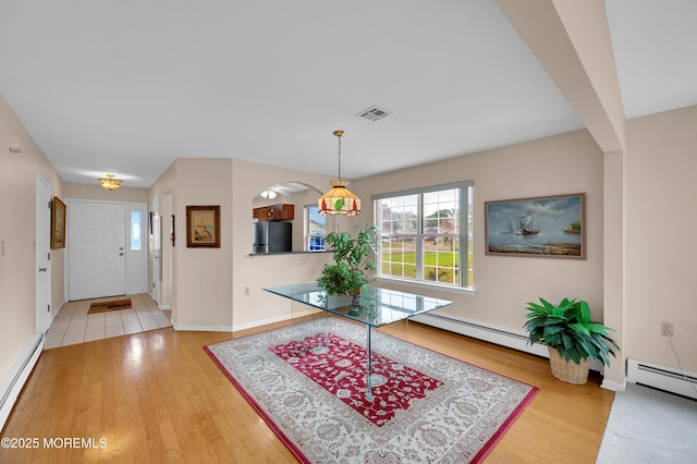 59 Mansfield Dr, Brick, NJ 08724 - foyer entrance featuring a baseboard heating unit, wood finished floors, and arched walkways