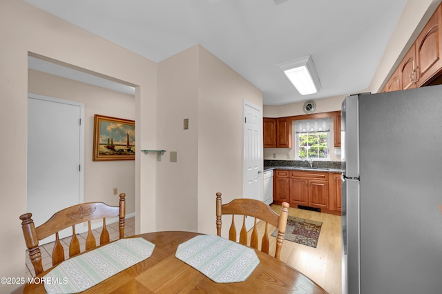 59 Mansfield Dr, Brick, NJ 08724 - kitchen featuring freestanding refrigerator, dishwasher, light wood-style flooring, and brown cabinetry