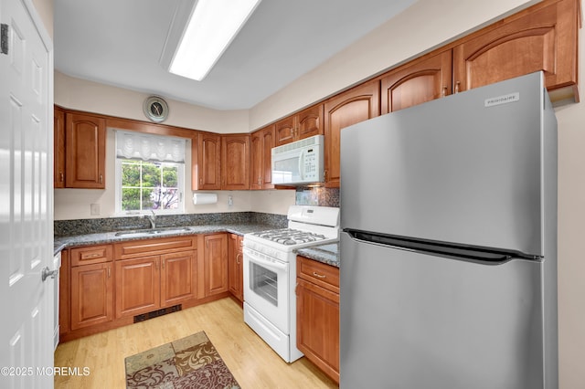 59 Mansfield Dr, Brick, NJ 08724 - kitchen featuring white appliances, brown cabinets, and light wood-style floors
