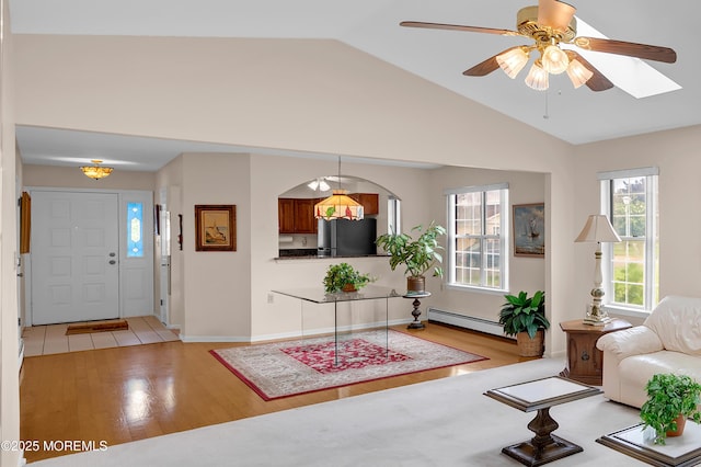 59 Mansfield Dr, Brick, NJ 08724 - living area with a baseboard radiator, plenty of natural light, light wood finished floors, vaulted ceiling, and ceiling fan