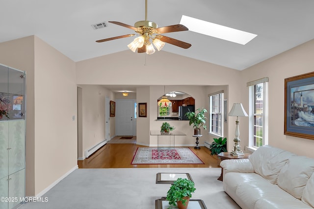 59 Mansfield Dr, Brick, NJ 08724 - living area featuring a baseboard heating unit, healthy amount of natural light, vaulted ceiling, wood finished floors, and a ceiling fan