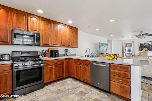 414 Bay Blvd Unit B, Seaside Heights, NJ 08751 - kitchen featuring stainless steel appliances, a peninsula, light countertops, brown cabinetry, and recessed lighting