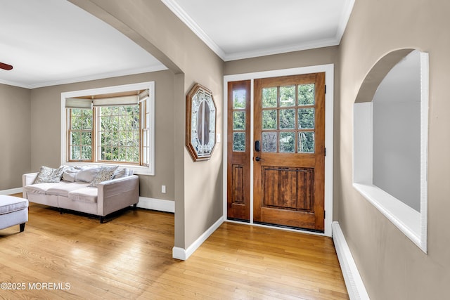 40 Centerville Rd, Holmdel, NJ 07733 - entryway featuring light wood-style flooring, crown molding, arched walkways, and a baseboard radiator