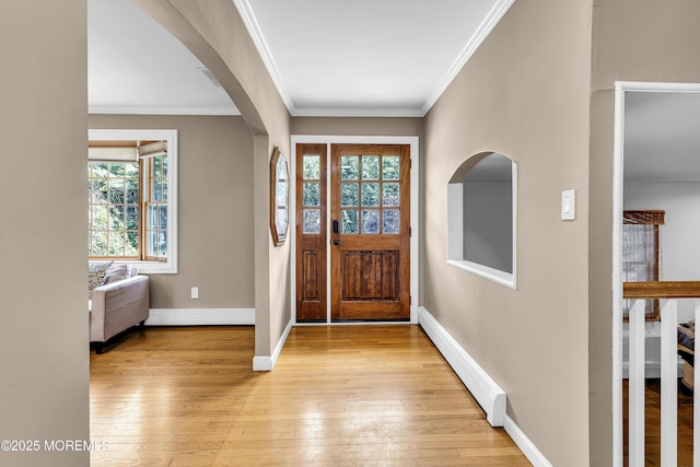 40 Centerville Rd, Holmdel, NJ 07733 - entrance foyer with arched walkways, light wood finished floors, crown molding, and a baseboard radiator