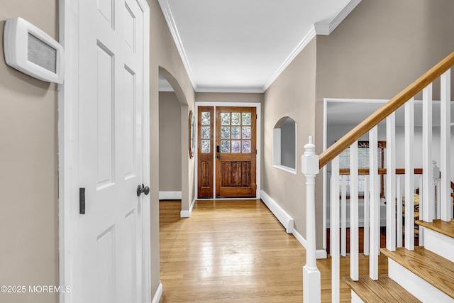 40 Centerville Rd, Holmdel, NJ 07733 - entrance foyer with baseboard heating, arched walkways, light wood finished floors, and crown molding
