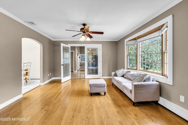 40 Centerville Rd, Holmdel, NJ 07733 - living room featuring a baseboard radiator, arched walkways, ornamental molding, light wood-style floors, and ceiling fan