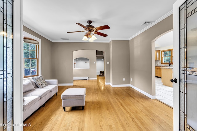 40 Centerville Rd, Holmdel, NJ 07733 - living area featuring arched walkways, ceiling fan, light wood-style floors, and crown molding