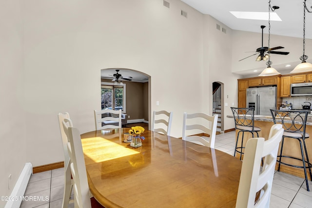 40 Centerville Rd, Holmdel, NJ 07733 - dining area with a ceiling fan, a baseboard radiator, arched walkways, a skylight, and high vaulted ceiling