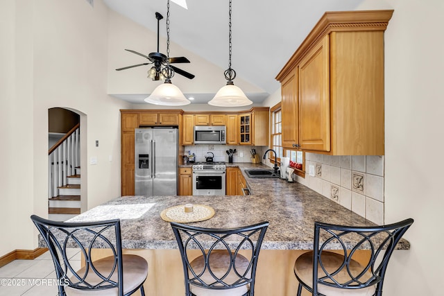 40 Centerville Rd, Holmdel, NJ 07733 - kitchen with stainless steel appliances, backsplash, a peninsula, a breakfast bar area, and high vaulted ceiling