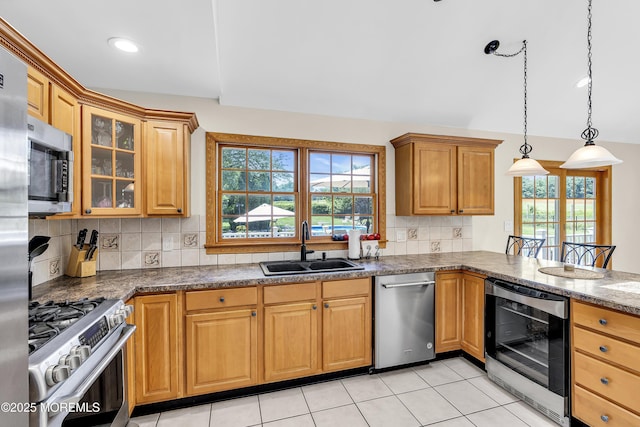 40 Centerville Rd, Holmdel, NJ 07733 - kitchen featuring appliances with stainless steel finishes, wine cooler, backsplash, glass insert cabinets, and pendant lighting