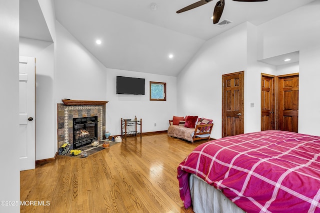 40 Centerville Rd, Holmdel, NJ 07733 - bedroom with vaulted ceiling, wood finished floors, a stone fireplace, recessed lighting, and ceiling fan