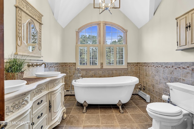 40 Centerville Rd, Holmdel, NJ 07733 - full bathroom featuring tile walls, a chandelier, a wainscoted wall, a soaking tub, and double vanity