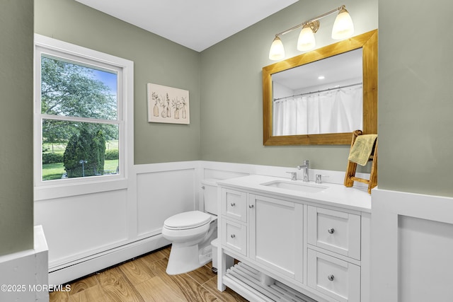 40 Centerville Rd, Holmdel, NJ 07733 - full bath with baseboard heating, a wainscoted wall, vanity, and wood finished floors