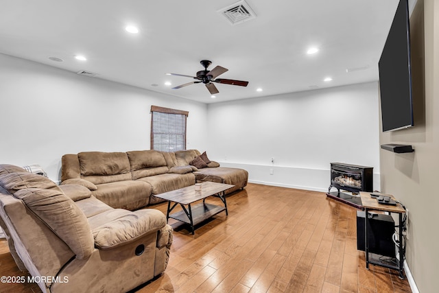 40 Centerville Rd, Holmdel, NJ 07733 - living room with a wood stove, ceiling fan, recessed lighting, and light wood-style floors