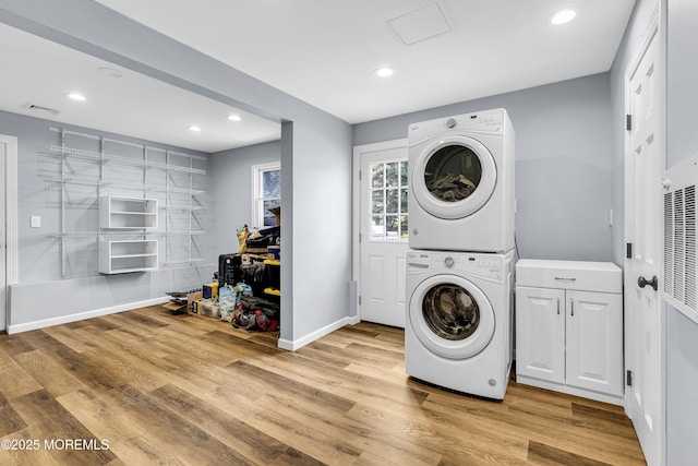 40 Centerville Rd, Holmdel, NJ 07733 - washroom featuring stacked washer and clothes dryer, recessed lighting, light wood-type flooring, cabinet space, and a heating unit