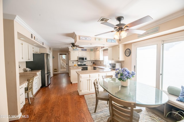 1920 Kenilworth Ct, Toms River, NJ 08753 - dining area featuring a ceiling fan, ornamental molding, wood finished floors, and stairway