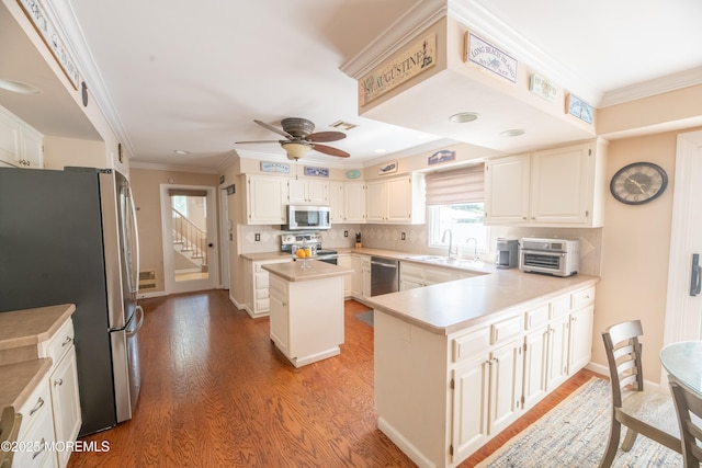 1920 Kenilworth Ct, Toms River, NJ 08753 - kitchen featuring appliances with stainless steel finishes, light wood-type flooring, light countertops, ceiling fan, and decorative backsplash