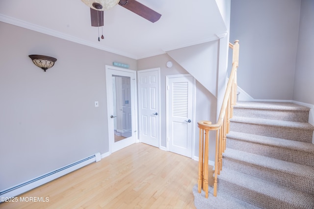 1920 Kenilworth Ct, Toms River, NJ 08753 - staircase featuring a baseboard heating unit, wood finished floors, ceiling fan, and ornamental molding