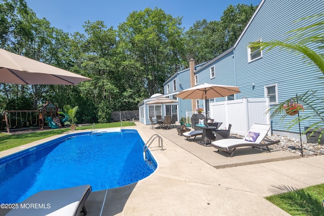 1920 Kenilworth Ct, Toms River, NJ 08753 - view of swimming pool featuring a patio, an outdoor structure, a playground, outdoor dining space, and view of scattered trees