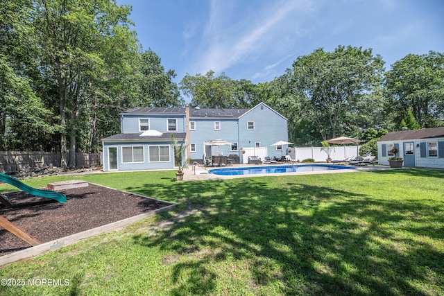 1920 Kenilworth Ct, Toms River, NJ 08753 - rear view of property featuring a fenced backyard, an outbuilding, and a patio