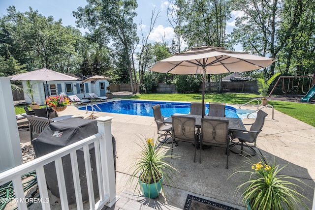 1920 Kenilworth Ct, Toms River, NJ 08753 - view of swimming pool with outdoor dining area, an outdoor structure, a fenced backyard, and a patio area
