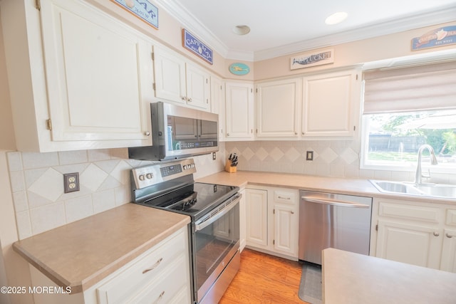 1920 Kenilworth Ct, Toms River, NJ 08753 - kitchen featuring stainless steel appliances, crown molding, light countertops, white cabinets, and light wood-style floors